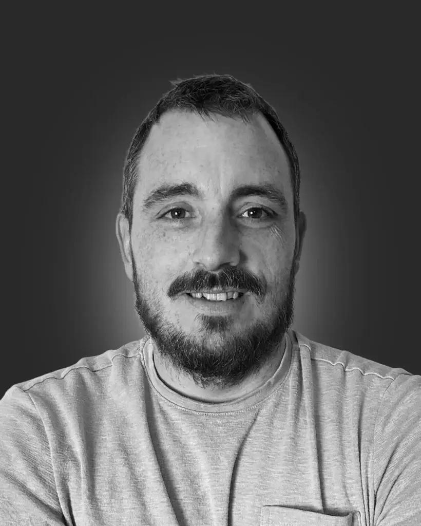 Smiling man with beard, gray background